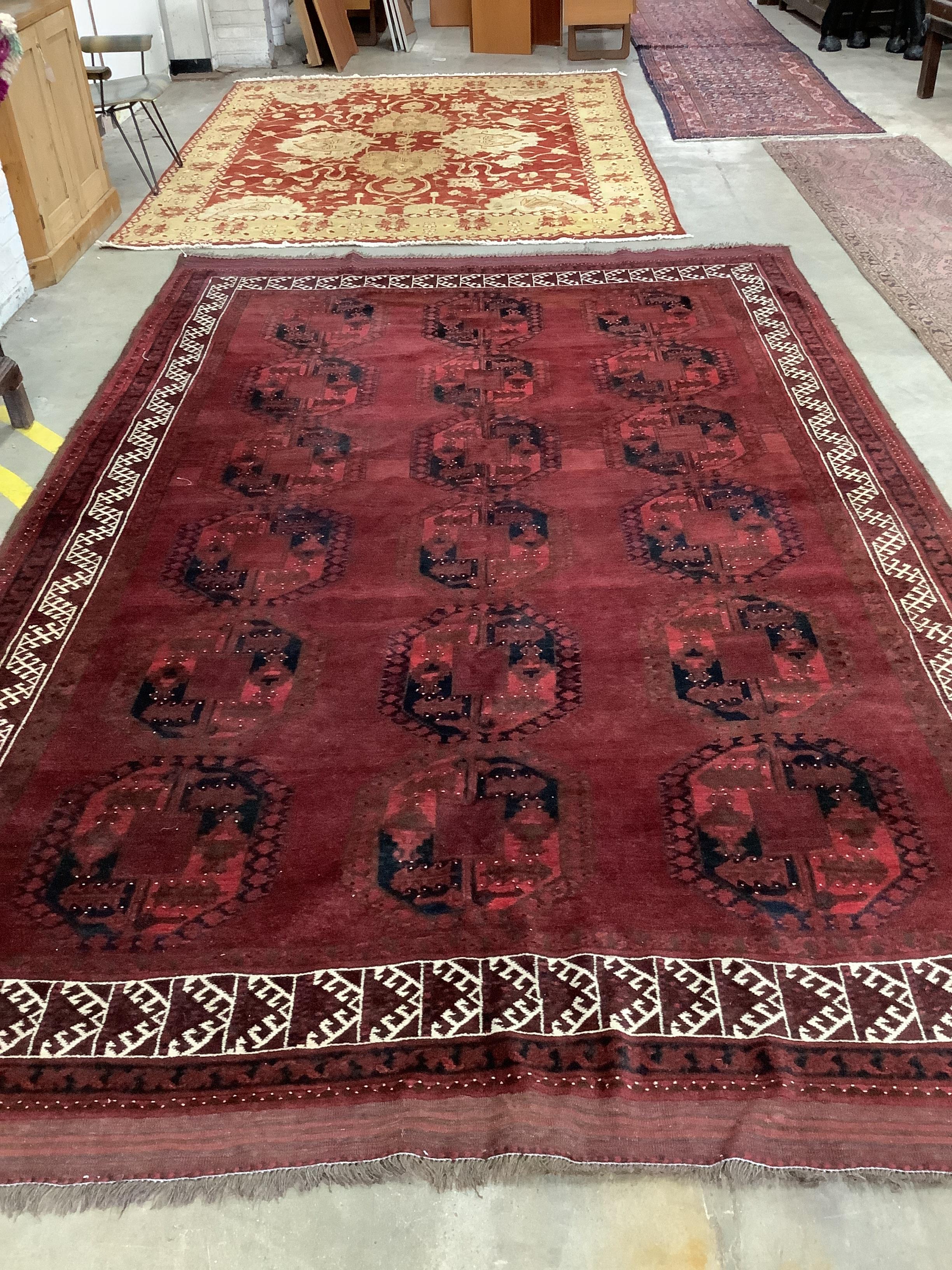 An Afghan red ground carpet, 380 x 243cm. Condition - fair